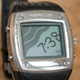 A small gallery of watch faces allowed users to customize their MSN Direct smartwatches, and many included animations that would run every minute, such as water rushing in and erasing the time on this beach.